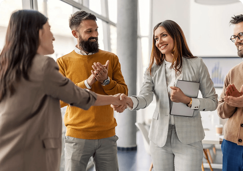 Colleagues congratulating each other at work