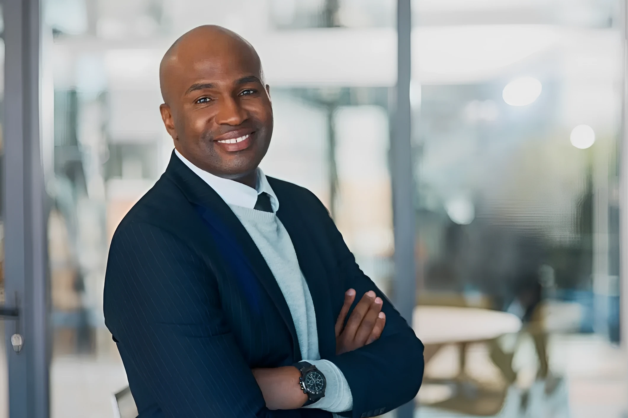 Smiling man in a business suit indoors.