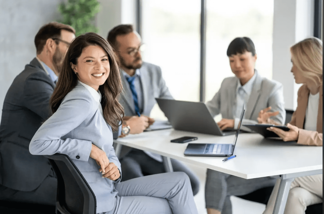 Smiling professionals in a business meeting.