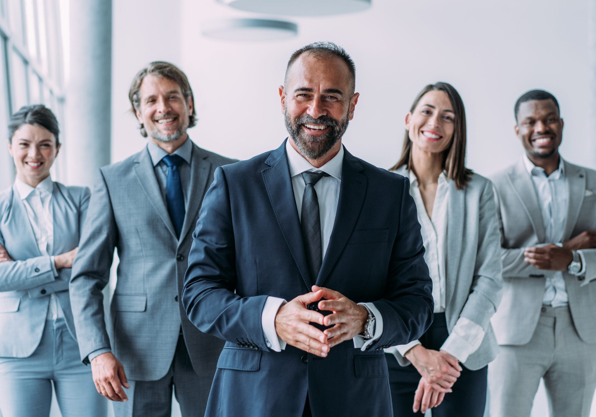Smiling business team in professional attire.