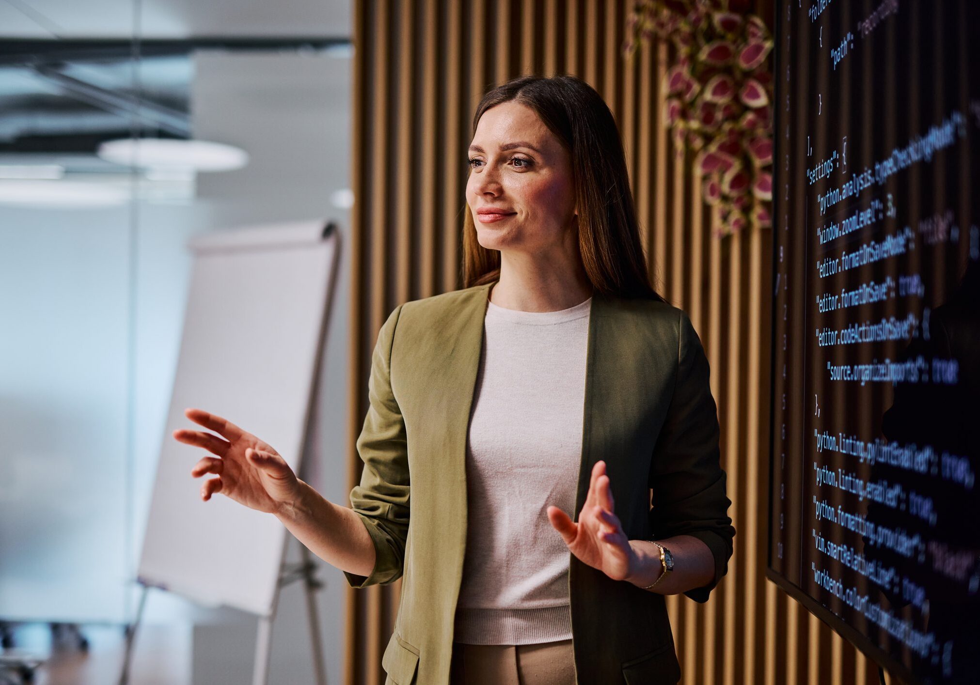Woman presenting in a modern office setting.