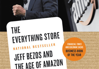 Bald man speaking beside nonfiction book cover